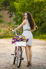 Image showing Happy girl with her bicycle