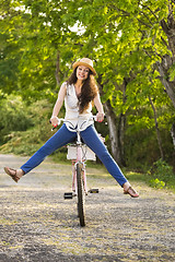 Image showing Happy girl with her bicycle