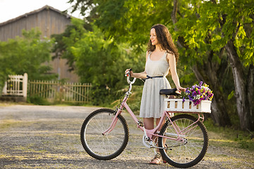 Image showing Happy girl with her bicycle