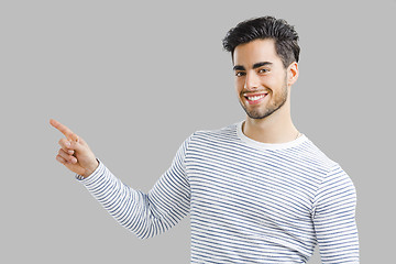 Image showing Handsome young man pointing