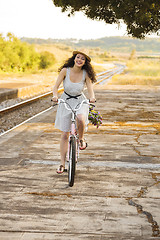 Image showing Happy girl with her bicycle