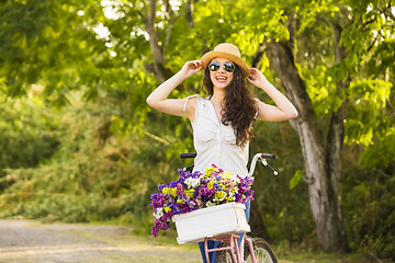 Image showing Happy girl with her bicycle