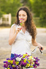 Image showing Happy girl with her bicycle