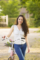 Image showing Girl with her bicycle