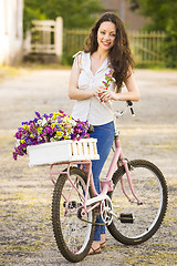 Image showing Happy girl with her bicycle