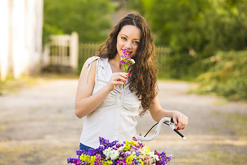 Image showing Happy girl with her bicycle