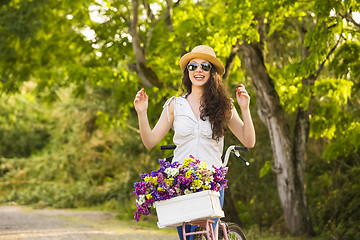 Image showing Happy girl with her bicycle