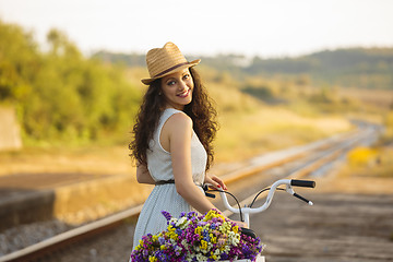 Image showing Happy girl with her bicycle