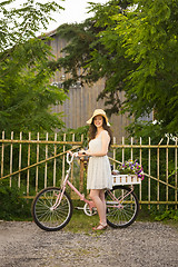 Image showing Happy girl with her bicycle