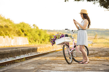 Image showing Happy girl with her bicycle