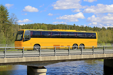 Image showing Yellow Coach Bus on Scenic Bridge