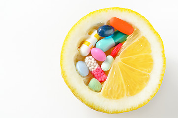 Image showing pills and lemon  isolated 