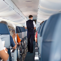 Image showing Steward on the airplane.
