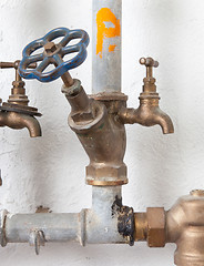 Image showing Old pipelines with blue valve