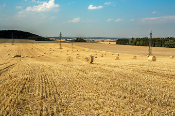 Image showing Beautiful landscape with straw bales in harvested fields