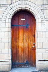 Image showing wooden parliament in door and marble antique  wall