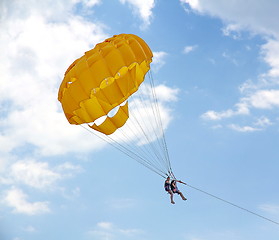 Image showing Parasailing in a blue sky near sea beach