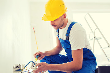 Image showing builder with tablet pc and equipment indoors