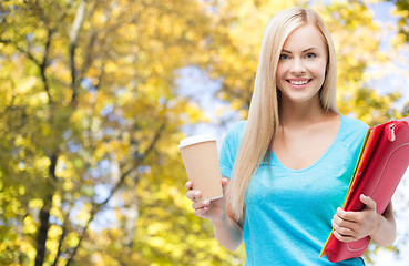 Image showing smiling student girl with folders and coffee cup