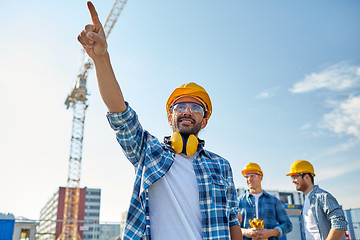 Image showing builders pointing finger aside on construction