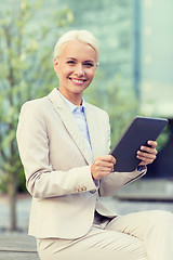 Image showing smiling businesswoman with tablet pc outdoors