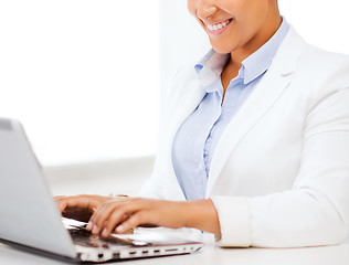 Image showing businesswoman with laptop in office