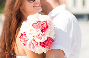 Image showing close up of couple with bunch flowers in city