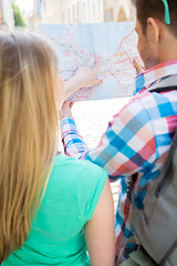 Image showing close up of couple with map and backpack in city