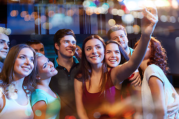 Image showing friends with smartphone taking selfie in club