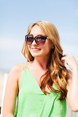 Image showing girl in shades in cafe on the beach