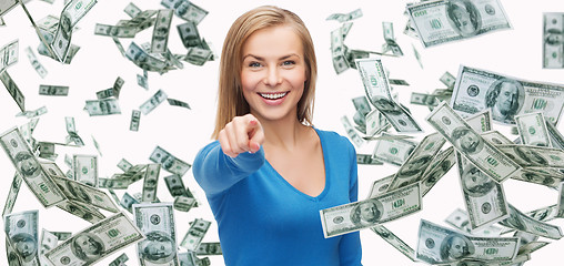 Image showing smiling woman with money pointing finger on you