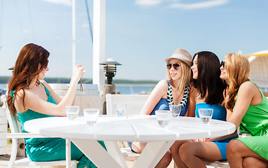 Image showing girls taking photo in cafe on the beach