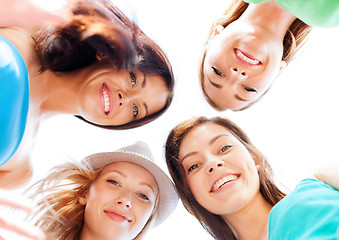 Image showing faces of girls looking down and smiling