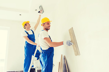 Image showing group of builders with tools indoors