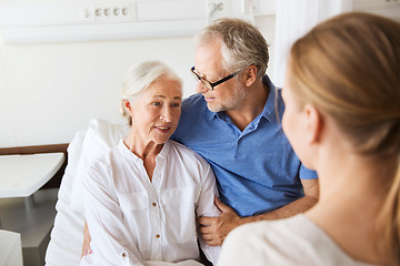 Image showing happy family visiting senior woman at hospital