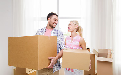 Image showing couple with big cardboard boxes moving to new home