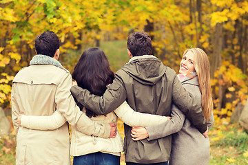 Image showing group of smiling men and women in autumn park