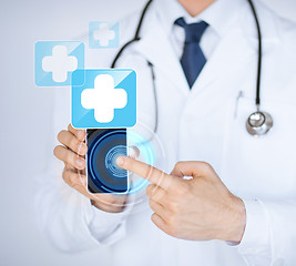 Image showing doctor holding smartphone with medical app