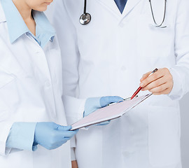 Image showing nurse and male doctor holding cardiogram