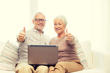 Image showing happy senior couple with laptop at home