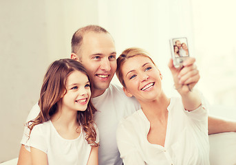 Image showing happy family with little girl making self portrait