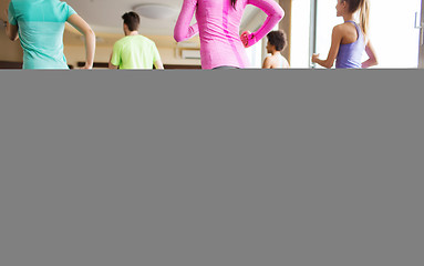 Image showing close up of people working out with steppers in gym