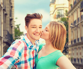 Image showing happy couple taking selfie over city background