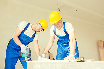 Image showing group of builders with tools indoors