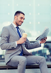 Image showing young businessman with coffee and newspaper