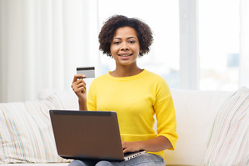Image showing happy african woman with laptop and credit card