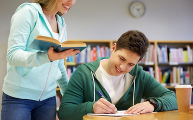 Image showing happy students preparing to exams in library