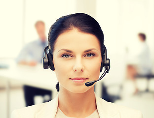 Image showing female helpline operator with headphones