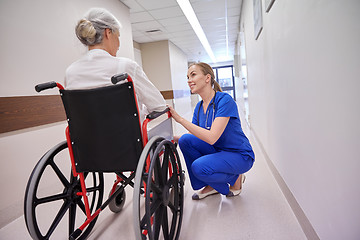 Image showing nurse with senior woman in wheelchair at hospital