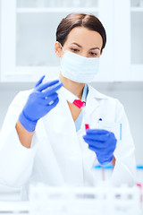 Image showing close up of scientist holding test tube in lab